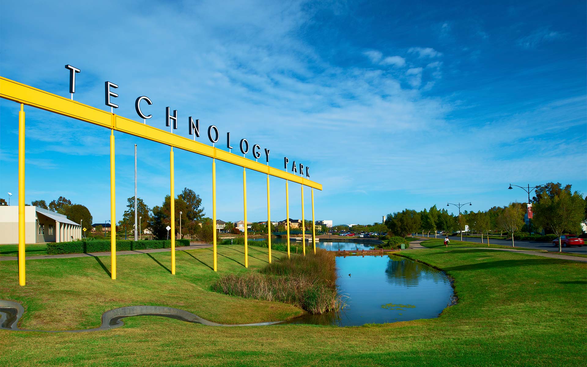 Technology Park sign in front of a small lake