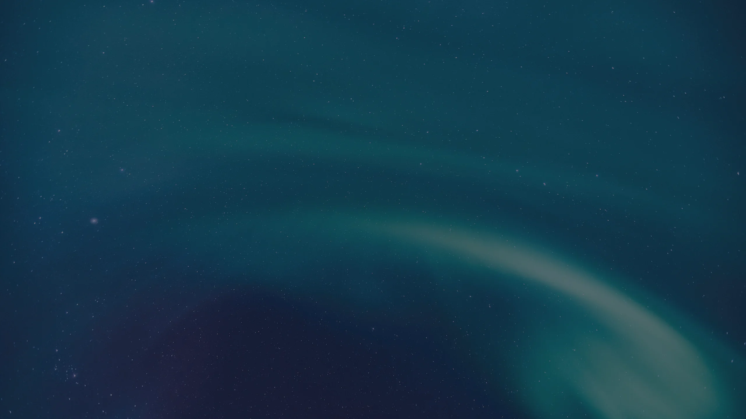 Greeny aurora in front of stars in a clear dark sky
