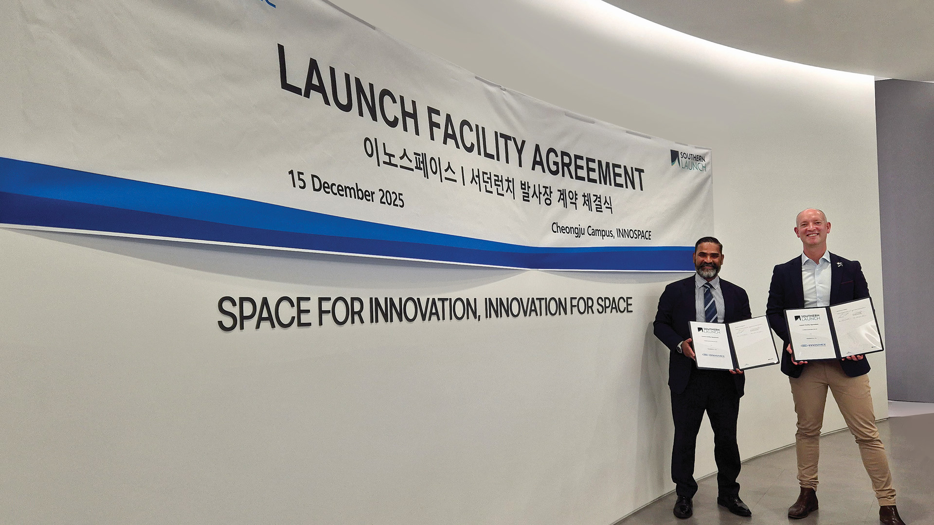 Two representatives from Southern Launch and INNOSPACE holding their newly signed contract agreements