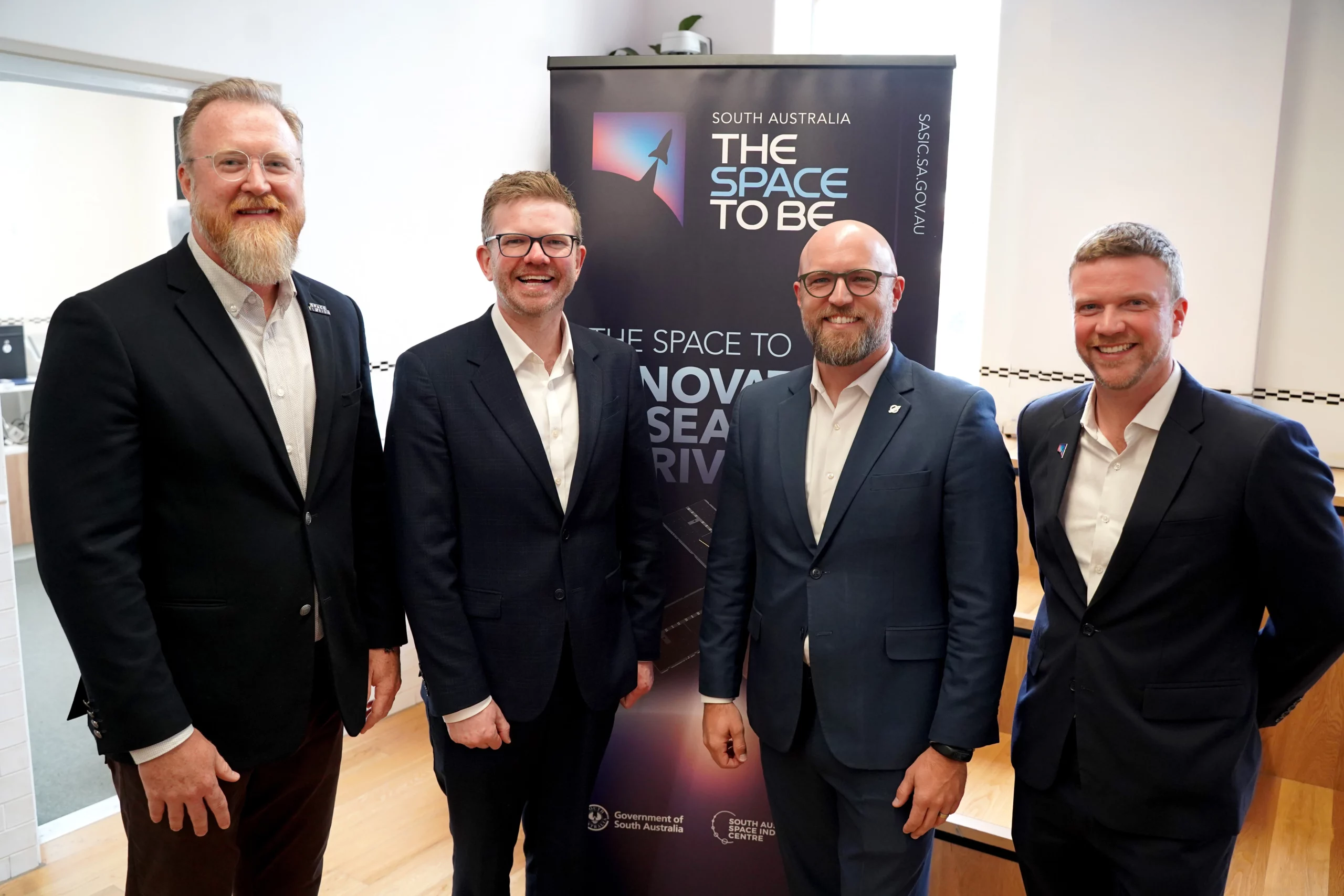 Space Florida announces MoU with SASIC Group of corporate men standing in front of a space branded banner in an open room